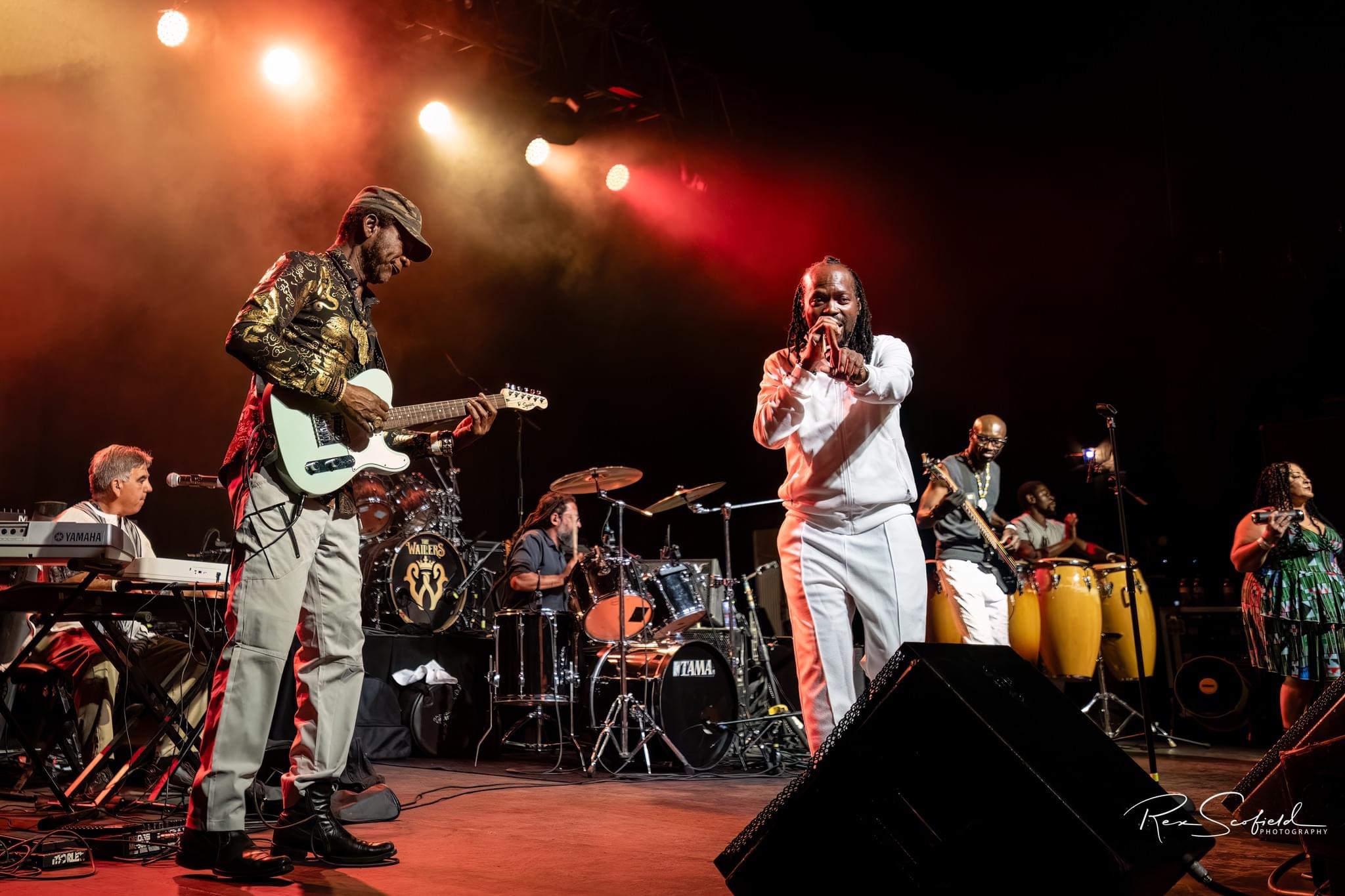 General Tchefary performing on stage with the full band